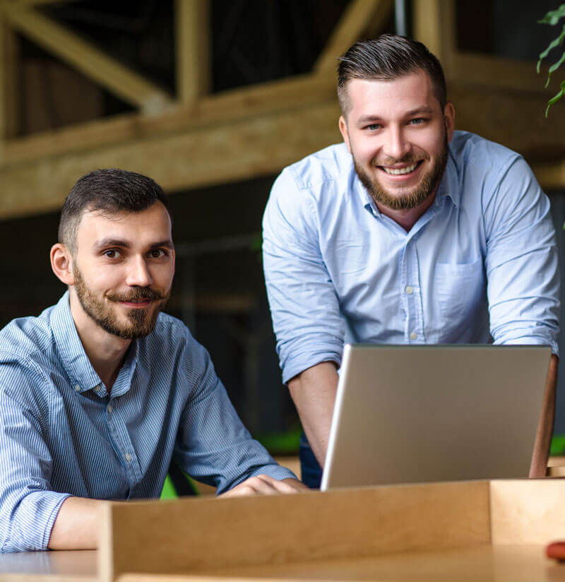 picture-handsome-businessman-listening-his-colleague-partner-concerning-ner-business-system-while-working-laptop-computer-office-interior